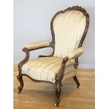 A Victorian carved mahogany button back parlour chair, padded arms, with carved cabriole front