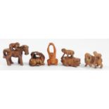 A Japanese wood netsuke of a monkey on a pig, signed, 5cm, a monkey on a water buffalo, signed and