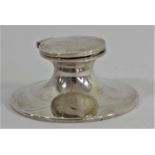 A silver capstan inkwell, Birmingham 1916, hinged cover, plastic ink holder, diameter 9cm, loaded