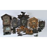 A collection of mid 20th century and later cuckoo clock parts, to include weights, cases and