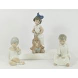 A Nao by Lladro figurine of My Lovely Lion 25cm together with two Spanish figurines of children,