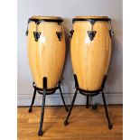 A pair of floor standing Bongos, lightwood, 74cm tall, on adjustable stands (2)