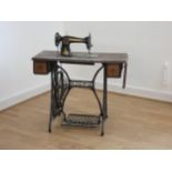 A Singer treadle sewing machine, model number F3456490, c1900, mounted on a hinged oak platform with