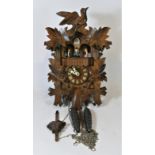 A Black Forest mechanical cuckoo clock, having musical carousel, with hand carved decoration, made
