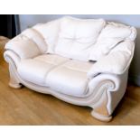 A beige leatherette three piece suite, sofa 170 x 75cm, chairs 127 x 75cm