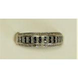A 9ct white gold, black and white diamond dress ring, staede weight 0.33ct, N, 2.6gm