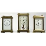 Three 8 day carriage clocks, brass cased with enamel dials having German and French movements. (3)