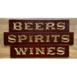 Three mahogany grocer's shop signs, hand carved, gilt decoration, to include Wine, 92cm x 20cm x