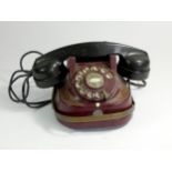 A Bell Telephone by the MFG Company, with brass carry handle, painted metal casing and Bakelite