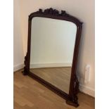 A large Louis Majorelle, Art Nouveau style overmantle mirror, bevel edged glass, carved and