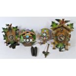Two mechanical cuckoo clocks, together with two chalet style novelty cuckoo clocks. (4)