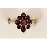 A 9ct gold and garnet cluster ring, M, 2.9gm