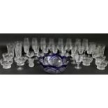 A collection of fine cut glass drinking glasses, together with a colbalt blue cut clear crystal