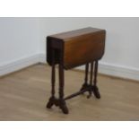 A Victorian mahogany pembroke table, raised on turned legs, having two drop leaves supported by