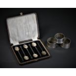 Three silver napkin rings, Birmingham 1942, 1960, Chester 1923 and a set of silver coffee bean