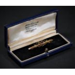 A 9ct gold and garnet bar brooch, Chester 1914, 44mm, 1.4gm, case.