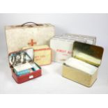 Seven first aid tins, with contents, a wooden first aid box, with carry handle, together with a