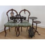 A pair of Victorian French carved mahogany side chairs, foliate carved cresting rails above scroll