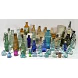 A collection of Edwardian and later glass bottles, to include Cod's pop bottles, various coloured