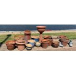 A collection of seventeen garden planters and pots, consisting of ceramic, terracotta and novelty