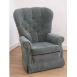 A Greensmith wingback armchair, fully upholstered in a cedar green velvet fabric, having