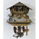 A large chalet style mechanical cuckoo clock, having musical carousel, automated water wheel &