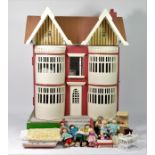A 1920s/30s detached wooden dolls house, double fronted, opening to reveal fitted interior, complete