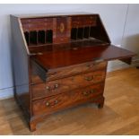 A George III mahogany bureau, the crossbanded fall opening to reveal fitted interior of small