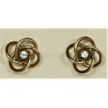 A 9ct gold brilliant cut diamond set ear studs, scroll setting, 1.8gm