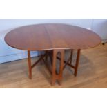 A 1970s teak gateleg drop-leaf dining table. L175cm, W107cm extended, together with a mahogany