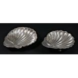 A silver shell shape dish, Sheffield 1914, raised on ball feet and another Birmingham 1908, 55gm