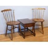 A pair of Swedish elm dining chairs by Elma, c1900s having spindle backs and penny seats, together