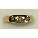 A Victorian style 9ct gold three stone garnet ring, star gypsy set, M, 1.5gm