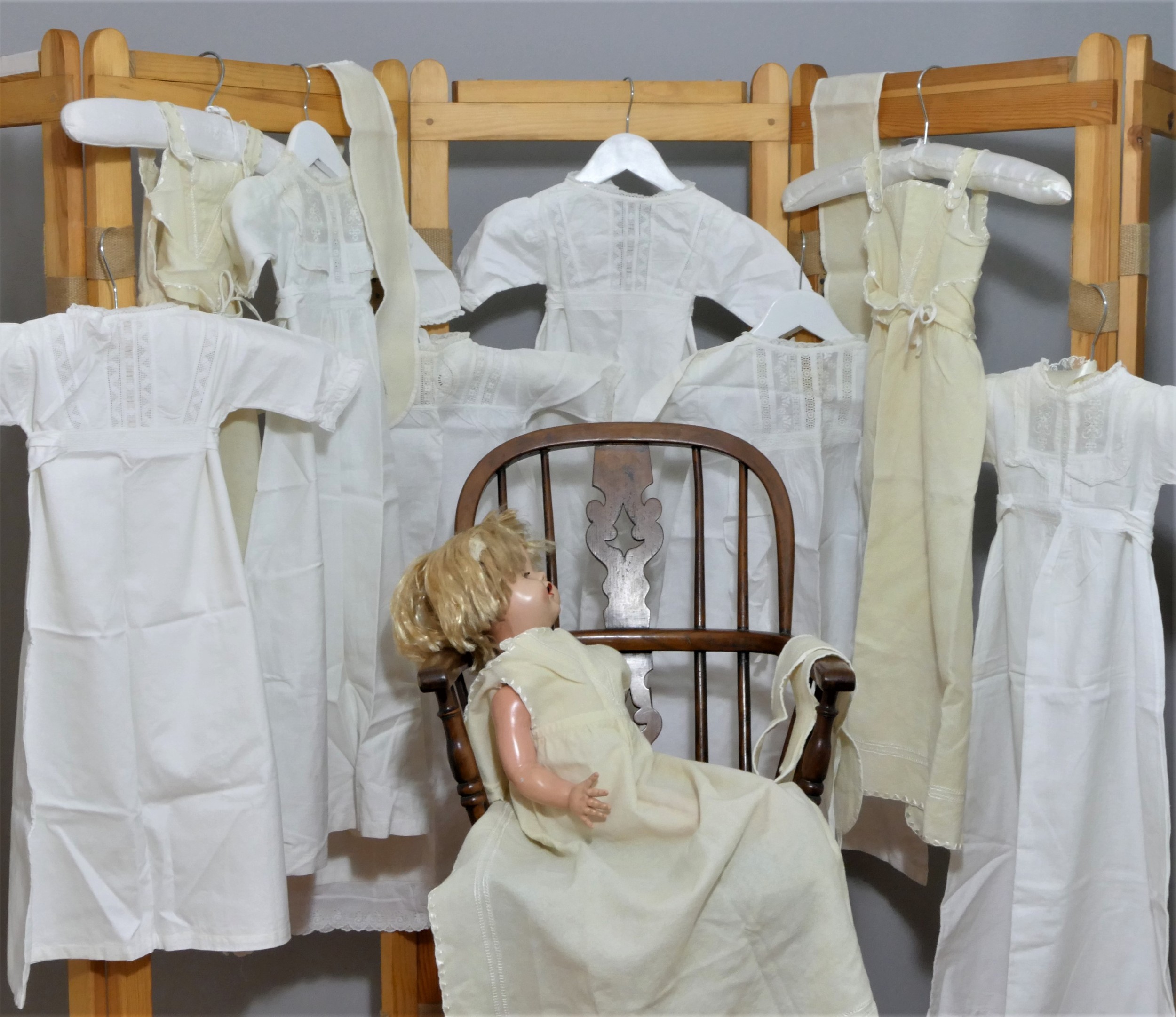 White cotton embroidered christening gowns and cream embroidered layettes. Average 64cm length (9)