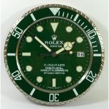 A quartz wall clock, in the form of an oversized Rolex 'Hulk' Submariner watch.