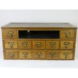 An early 20th Century oak index chest, with a bank of twelve drawers (three missing) W84cm, D44cm,