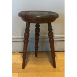 An early 20th Century 3 legged oak stool, having carved circular top raised on turned legs. 28cm