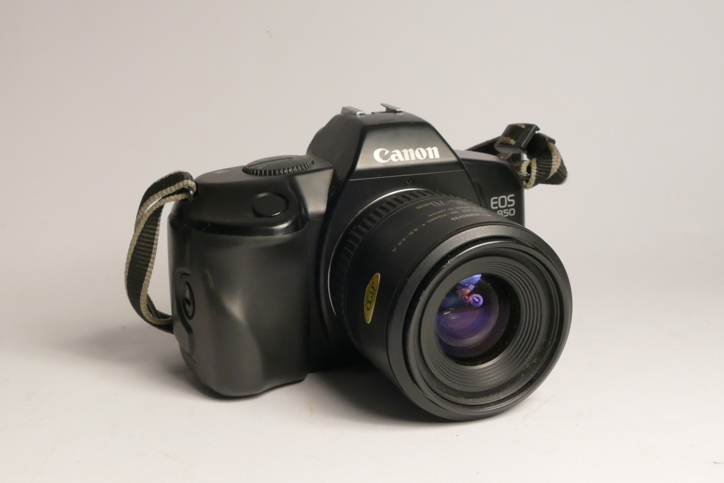 A Canon EOS 850 35mm film camera, with a Canon EF 35-70mm f3.5-f4.5A lens, a Canon 160F Speedlite,