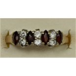 A 9ct gold garnet and gemstone ring, K, 1.5gm