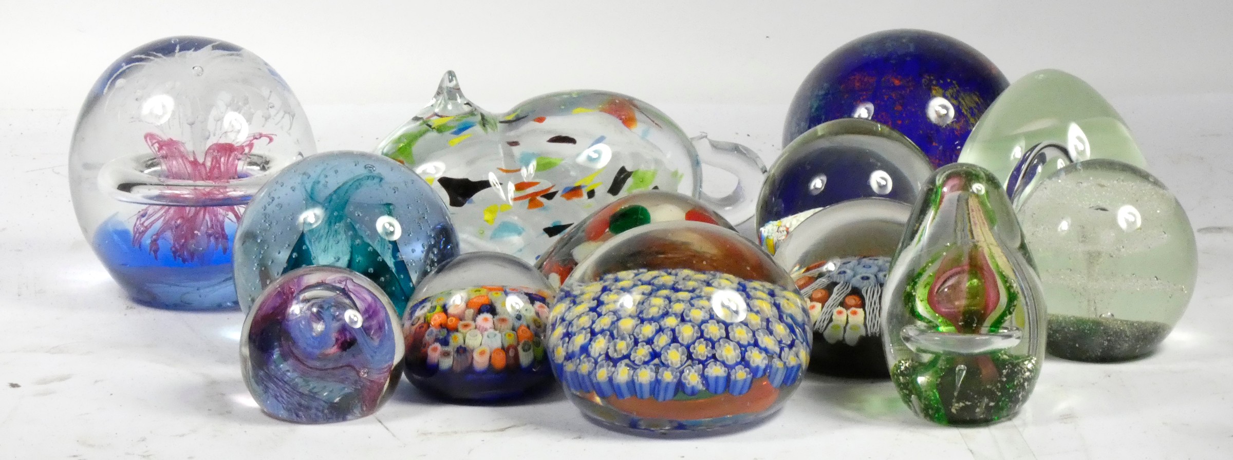 A collection of mid 20th century paperweights to include a Caithness example, together with twelve