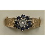 A 9ct gold sapphire and diamond cluster ring, textured mount, L 1/2, 2.5gm