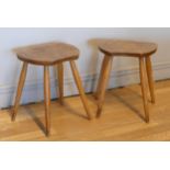 A pair of Ercol Blonde elm and beech saddle stools, c.1960s, stamped to underside - B.S 1960, B.J