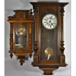 A large mahogany cased Vienna style 8 day wall clock, 88cm long, together with a smaller example. (
