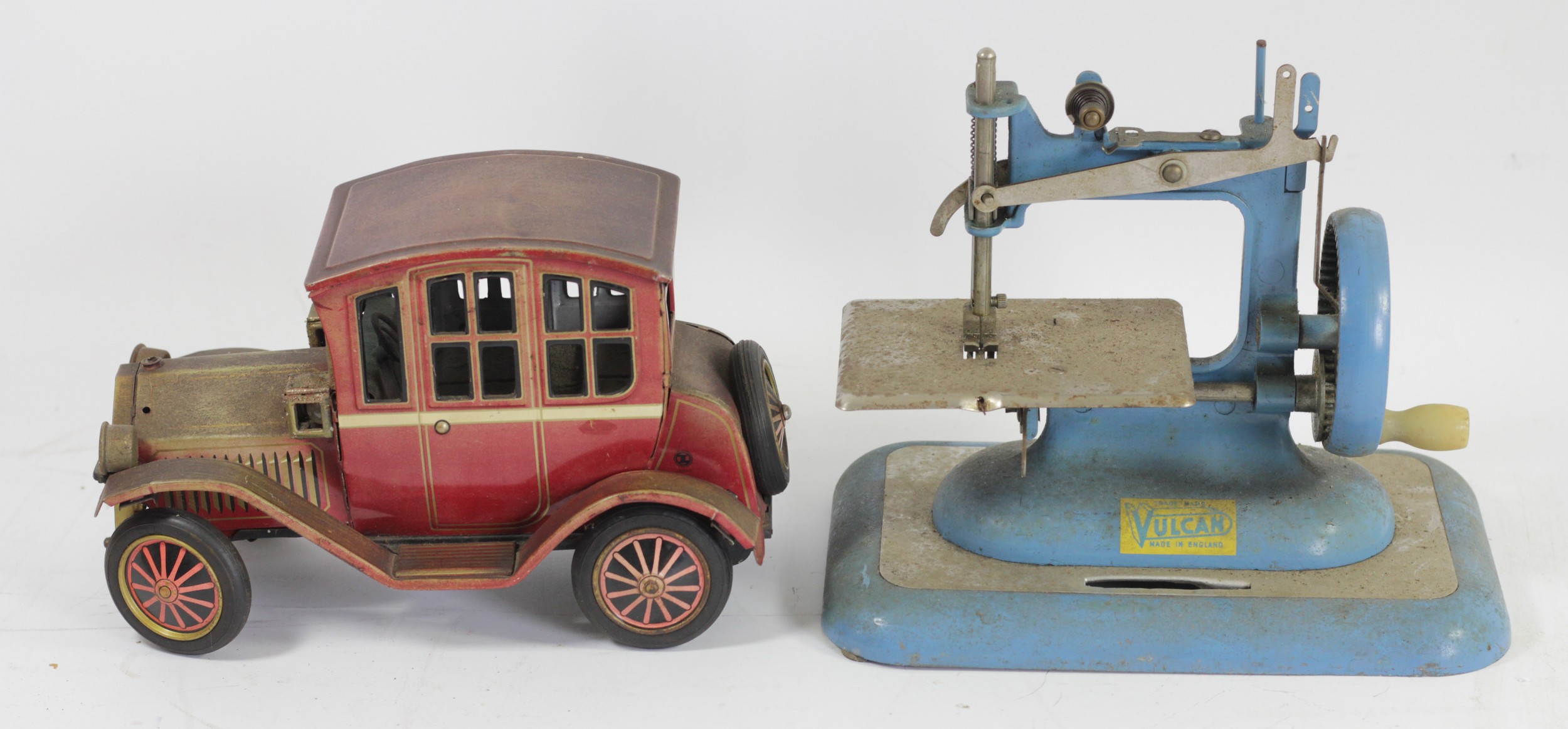 A tinplate car, friction rear wheel producing a mock engine noise, together with a Vulcan sewing