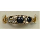 A 9ct gold Victorian style three stone sapphire ring (one setting vacant), diamond points between,