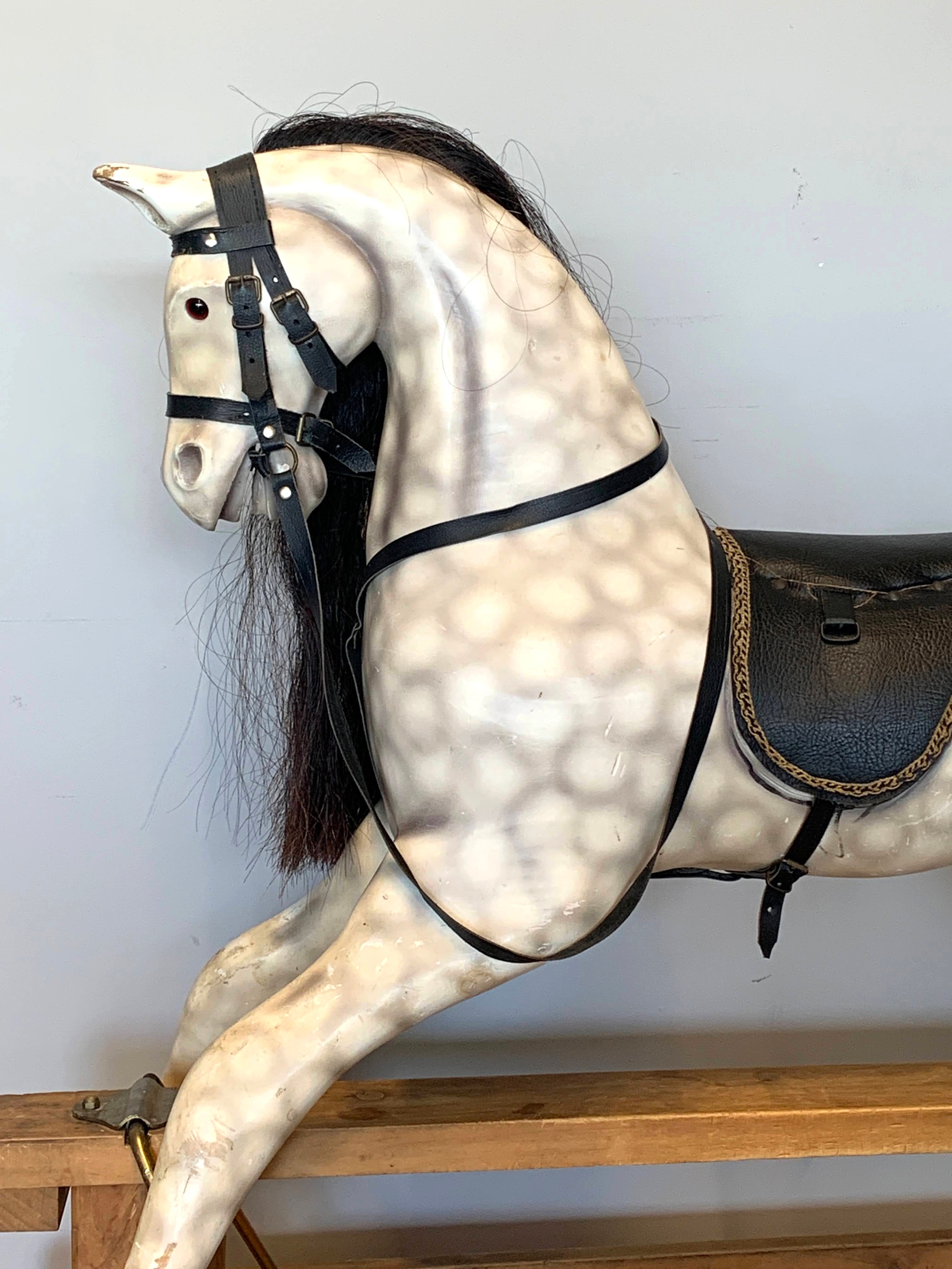 A large child's painted wood rocking horse, finished in a dapple grey with black leather saddlery, - Image 2 of 6