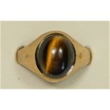 A 9ct gold and cabochon tigers eye signet ring, S, 3.7gm