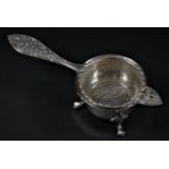 A silver tea strainer with stand, Birmingham 1972, 99gm