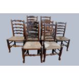 An 18th century matched set of eight (6 + 2) oak ladder back chairs with rush seats. Sold with a