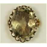 A 9ct gold and smokey quartz dress ring, London 1976, claw set with an oval mixed cut stone, 20 x